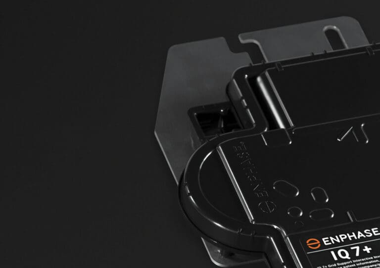 A black battery pack on a black background.