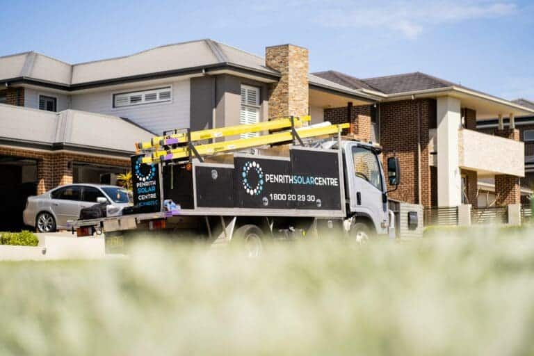 A truck is parked in front of a house.