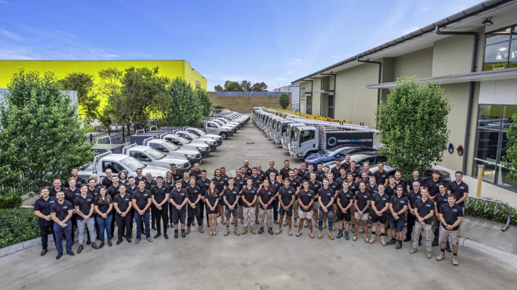 A group of people posing in front of a building.