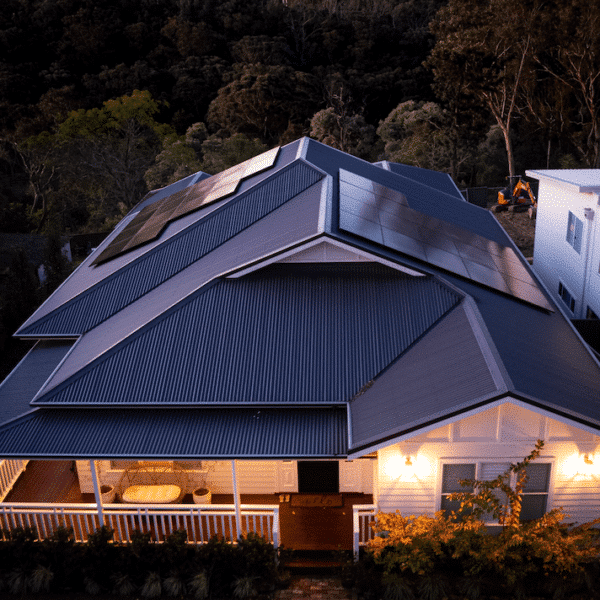 An aerial view of a house with solar panels on the roof.