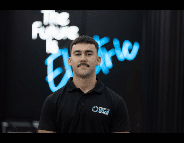 Man standing in front of a screen with the text "the future is defi" displayed.